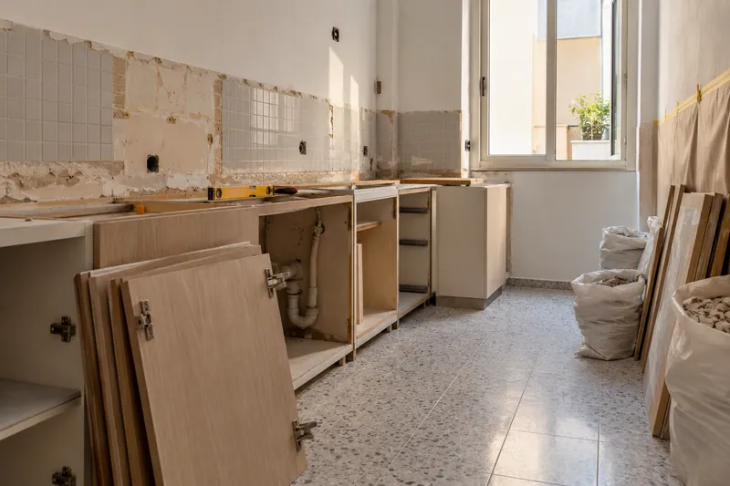 Visualización conceptual IA: Retirada de muebles y revestimientos al comienzo de una reforma de cocina.